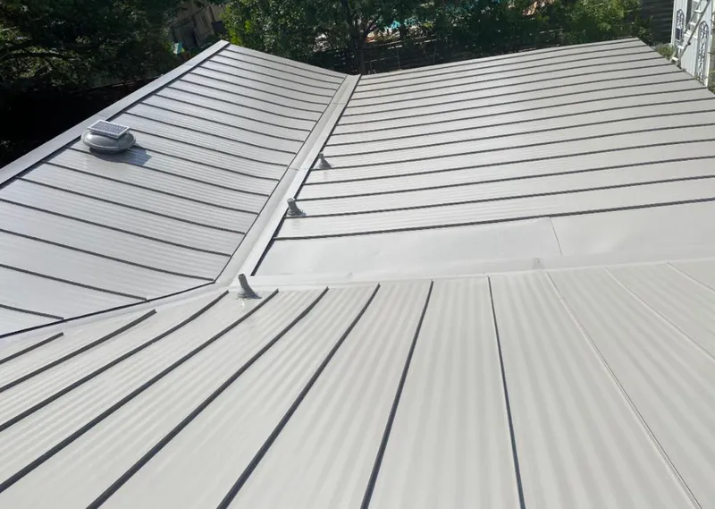 Solar attic fan installed on a metal roof for Roof Ventilation in Ohio